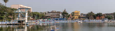 Kolkata, India - February 2, 2020: Panoramic view over a water park with diving tower and a water polo goal with unidentified people in the background on February 2, 2020 in Kolkata, Indiaのeditorial素材