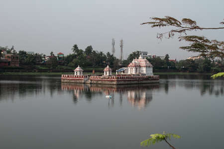 Bhubaneswar, India - February 4, 2020: Reflection of a red and white temple in Bindu Sagara lake on February 4, 2020 in Bhubaneswar, Indiaのeditorial素材
