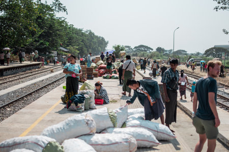 Yangon, Myanmar - December 31, 2019: Local burmese people attending a fruit and vegetables market by...