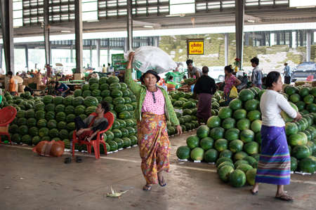 YANGON, MYANMAR - DECEMBER 31 2019: Huge piles of fresh watermelons at a local street market in Myanmarのeditorial素材
