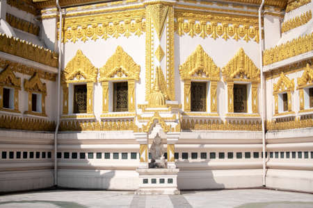 YANGON, MYANMAR - JANUARY 1 2020: Sunlight hits the decorated and detailed Swe Taw Myat Pagoda with a statueのeditorial素材