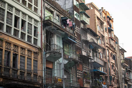 YANGON, MYANMAR - DECEMEBER 31 2019: Street view of a normal residencial  apartment building with...