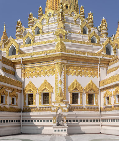 YANGON, MYANMAR - JANUARY 1 2020: Sunlight hits the decorated and detailed Swe Taw Myat Pagoda with a statueのeditorial素材