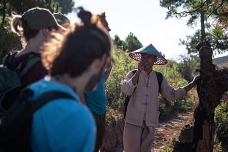 Shan state, Myanmar - January 6 2020: A burmese hike tour guide in traditional clothing smile while on hike From Kalaw to Inle Lakeのeditorial素材