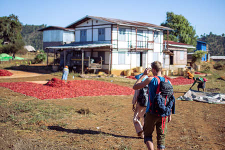 Shan state, Myanmar - January 6 2020: A backpacker visits a local chili farm plantation on a hike from Kalaw to Inle Lakeのeditorial素材