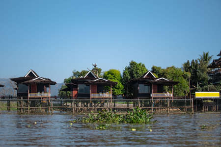 Red elevated buildings by the riverside of the canals at Inle Lake, Nyaung Shwe, Shan state, Mayanmarの写真素材