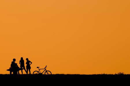 Teenagers talking on sunsetの写真素材