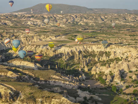 Hot air balloon flying over landscape at Cappadocia Turkeyのeditorial素材