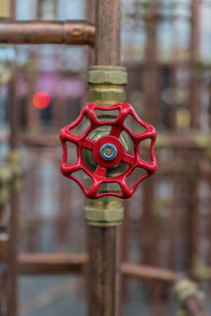 red valve on copper pipe (art construction)の写真素材