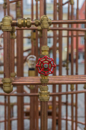 red valve on copper pipe (art construction)の写真素材