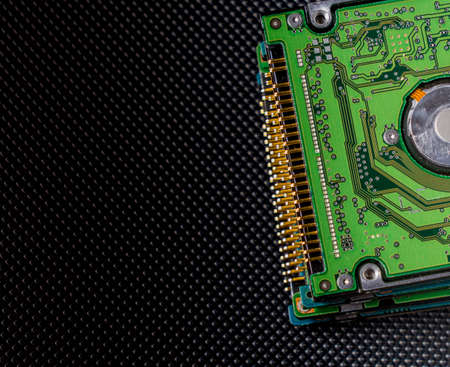 old hard disk drive on black backgroundの写真素材