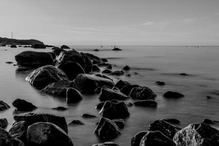 Beautiful Baltic sea landscape with stone breakwater. Tranquil long exposure landscape