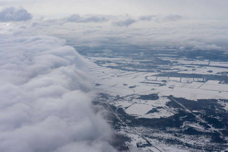 Aerial view of city with clouds, winter-time
