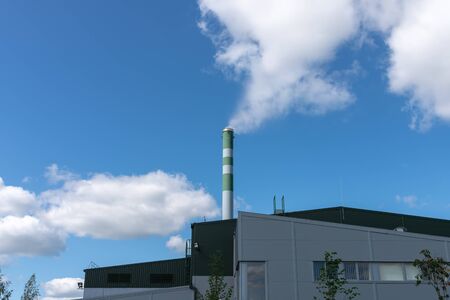 The pipe from which the smoke goes against the gray sky. The concept of air pollution, CO2, carbon dioxide gas, exhaust gases.の写真素材