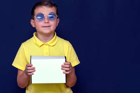 Close up Delivery kid boy in casual clothes Showing clipboard Holding Box looking at youの写真素材
