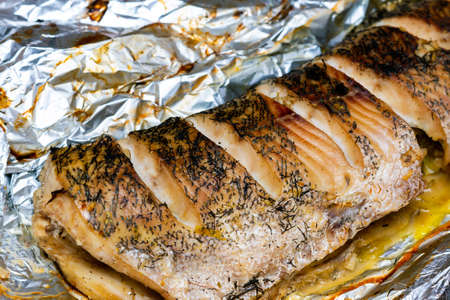 lying down fish cooking in the oven, pike lie in a foilの写真素材