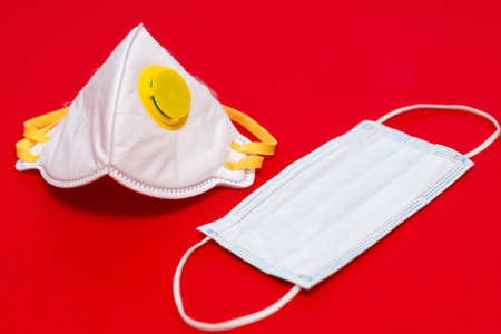 coronavirus - 2019-nCoV, virus concept. Surgical mask and respiratory protective mask. Red background.Copy space,mock up.の写真素材