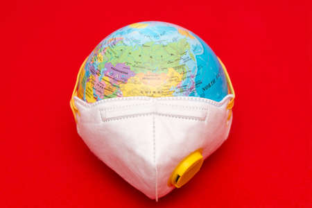 Top view photo.Coronavirus - 2019-nCoV, virus concept. a world globe with a protective respiratory...
