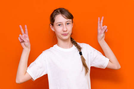 Close up photo of beautiful little girl arms showing v sign symbol say hi friends good mood wear...