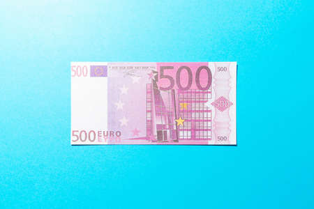 Flat lay top view one banknote play money 500 euro bill on blue background