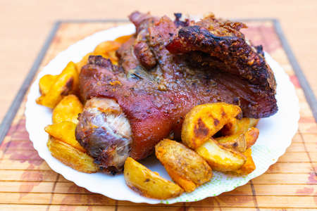 Top view close up tasty pork shank and mashed potato on the plate closeup. Verticalの写真素材