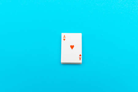 deck of cards playing cards over blue background with a red heart on top copy space