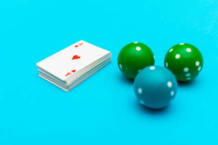 Ace of hearts and three dice lie on blue pastel background. Top view