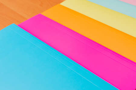 Top view Collection of multi colorful papers lying on the table.