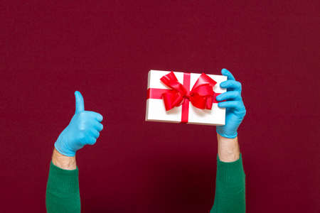 New Year's 2021. Christmas celebration, protection from coronavirus. Man hands wearing medical...