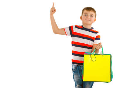 Closeup Young kid boy,holding shopping multicolored bags Holiday Sale. white background.の写真素材