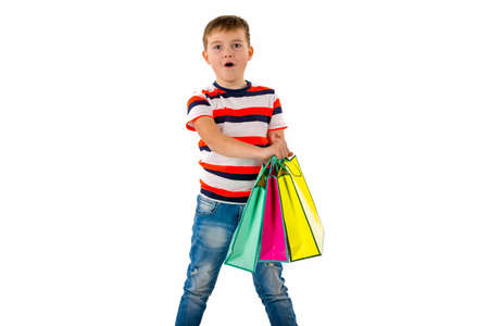 Closeup Young kid boy,holding shopping multicolored bags Holiday Sale. white background.の写真素材