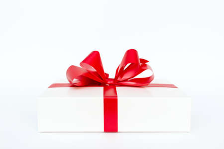 Cristmas white gift box present red bow white studio background.の写真素材