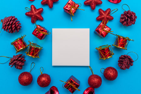 Merry Christmas flat lay frame made from decorations on blue background. copy space for text.Christmas concept.の写真素材