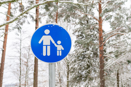 Blue sign parental supervision or walking area in the winter forest outdoorsの写真素材