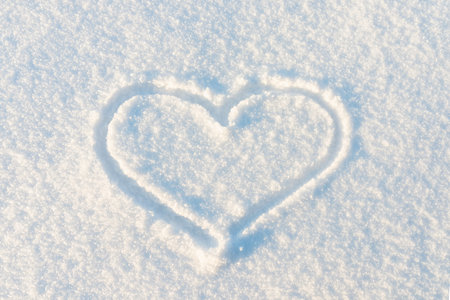 Drawn Heart shape on the snow.Top view image.の写真素材