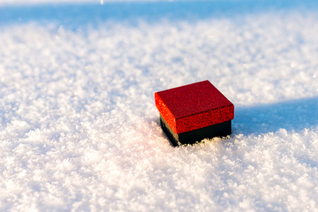 Red black gift flat lay on the snow. Valentine's day , place for text, love heart. Winter outside.の写真素材