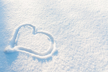 Drawn Heart shape on the snow.Top view image.Copy space.の写真素材