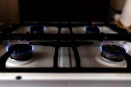 Gas burning kitchen gas stove at home evening.