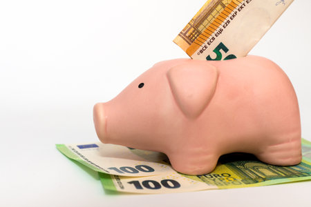 Business concept. Serious pink piggy bank on white background.の写真素材