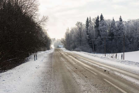 Winter road in snowy forest on a nice cold day.