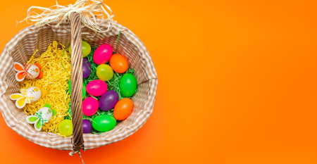 Basket Colorful Easter eggs bunny rabbits ears. Funny Easter concept.Copy space.Panoramic view.