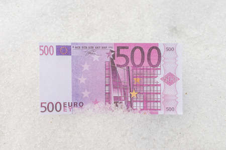 Five hundred euro banknote flat lay on a white snow background.の写真素材