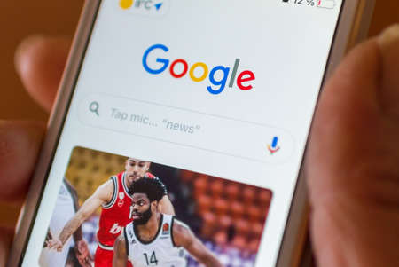 Smartphone with Google logo on the screen. White background. Google is the biggest Internet search app in the world. Telsiai Lithuania 02 March 2021のeditorial素材