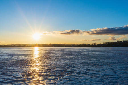 Beautiful winter landscape with frozen lake and sunrise sky. Composition of nature.の写真素材