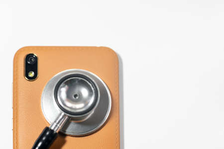 Stethoscope with smart phone. on white, abstract background to solution or key of solution problem for smart phone.Stethoscope with mobile phone on white background.の写真素材