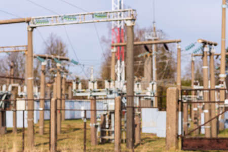 Blurry image Rows of electrical equipment in switchyard.Electric high voltage on blue sky