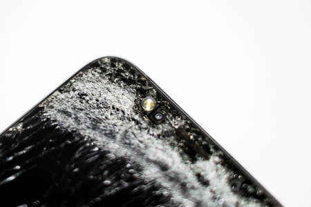 Mobile phone with broken screen on white background.Closeup.の写真素材