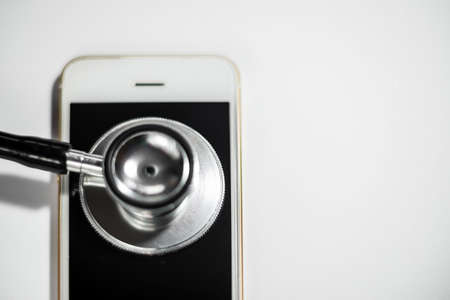 Stethoscope with smart phone. on white, abstract background to solution or key of solution problem for smart phone.Stethoscope with mobile phone on white background.Copy paste.の写真素材