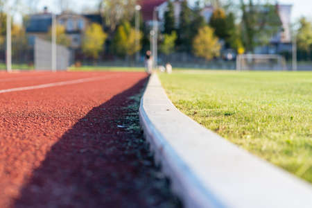 Red plastic track in the outdoor track and field stadium.Closeup.の写真素材