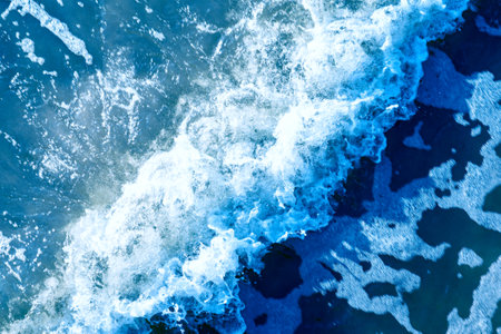 Areal shot of deep blue and rough sea with lot of sea spray.Blue background.Soft focus,blurred image.の写真素材